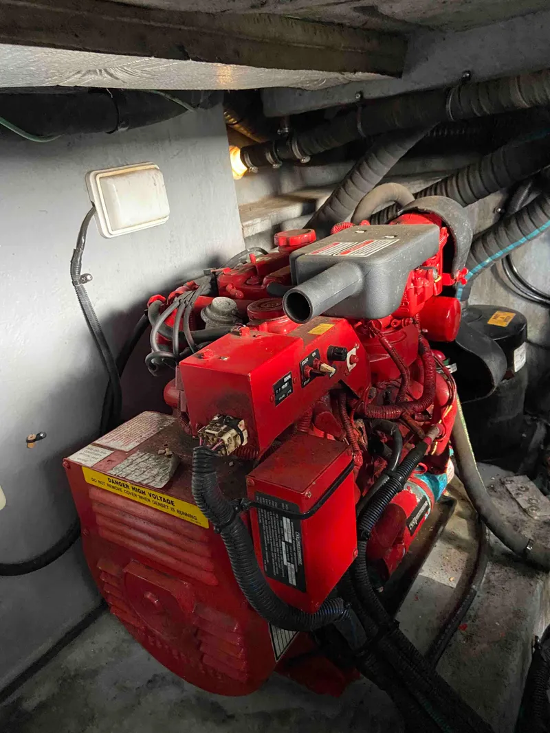 Slide: The Image of Red engine in 2002 Sea Ray 380 Sundancer boat, surrounded by cables and hoses. - 22