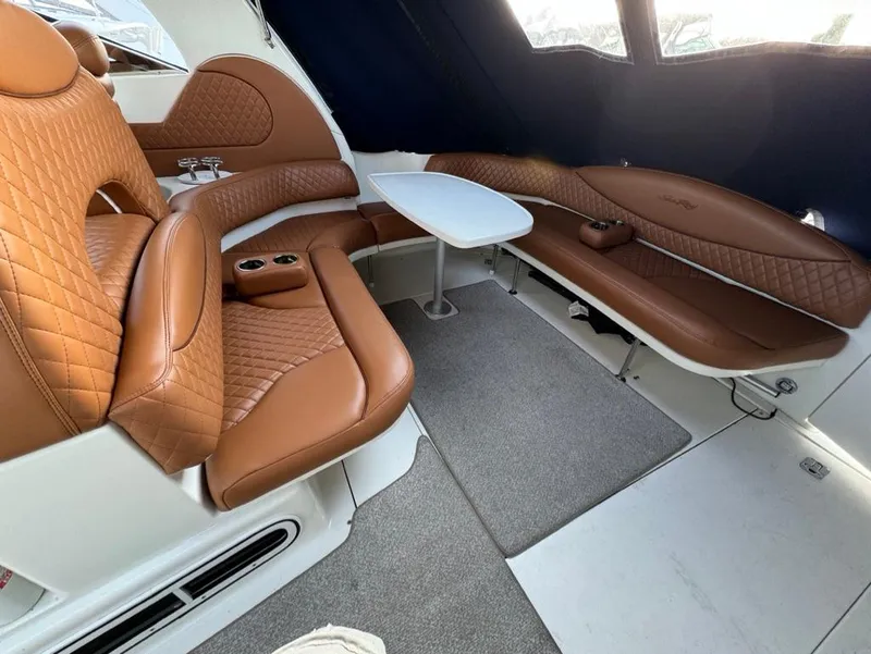 Slide: The Image of Luxurious interior of 2002 Sea Ray 380 Sundancer with brown leather seating and table. - 4