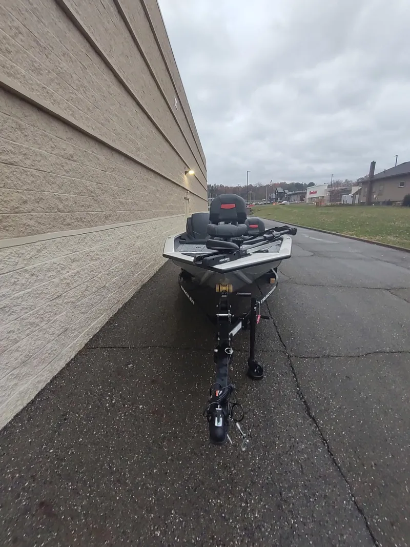 Slide: The Image of 2025 Tracker Pro Team 175 Crappie Edition boat parked on pavement. - 3