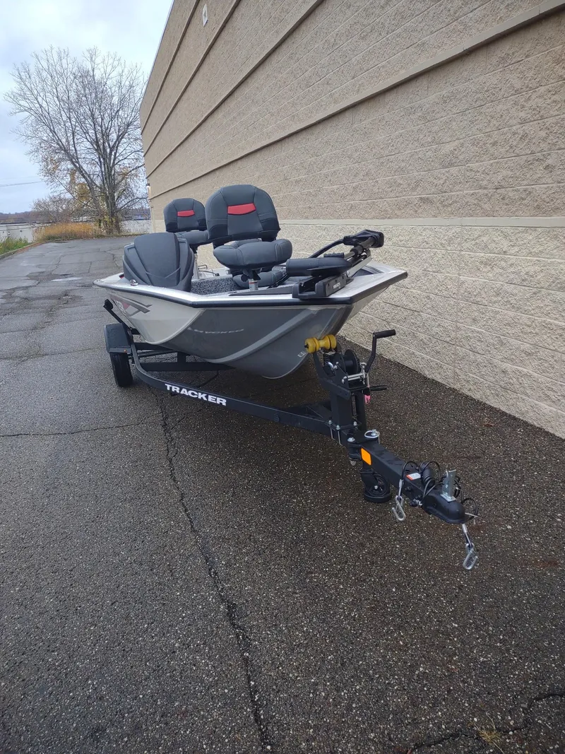 Slide: The Image of 2025 Tracker Pro Team 175 Crappie Edition boat on trailer, parked outdoors. - 5