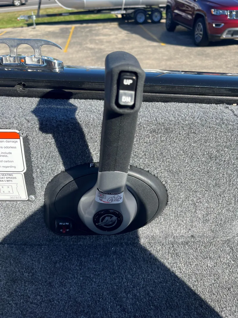 Slide: The Image of 2025 Tracker Pro Guide V-175 Combo throttle control lever on boat deck. - 10