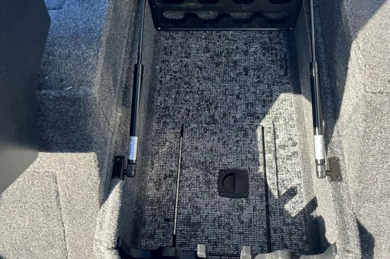 Slide: The Image of 2025 Tracker Pro Guide V-175 Combo interior storage compartment with carpeted finish. - 11