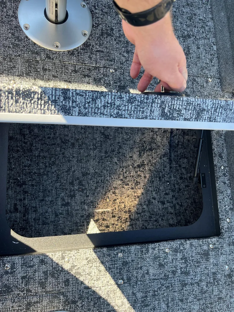 Slide: The Image of 2025 Tracker Pro Guide V-175 Combo boat storage compartment with textured flooring. - 12