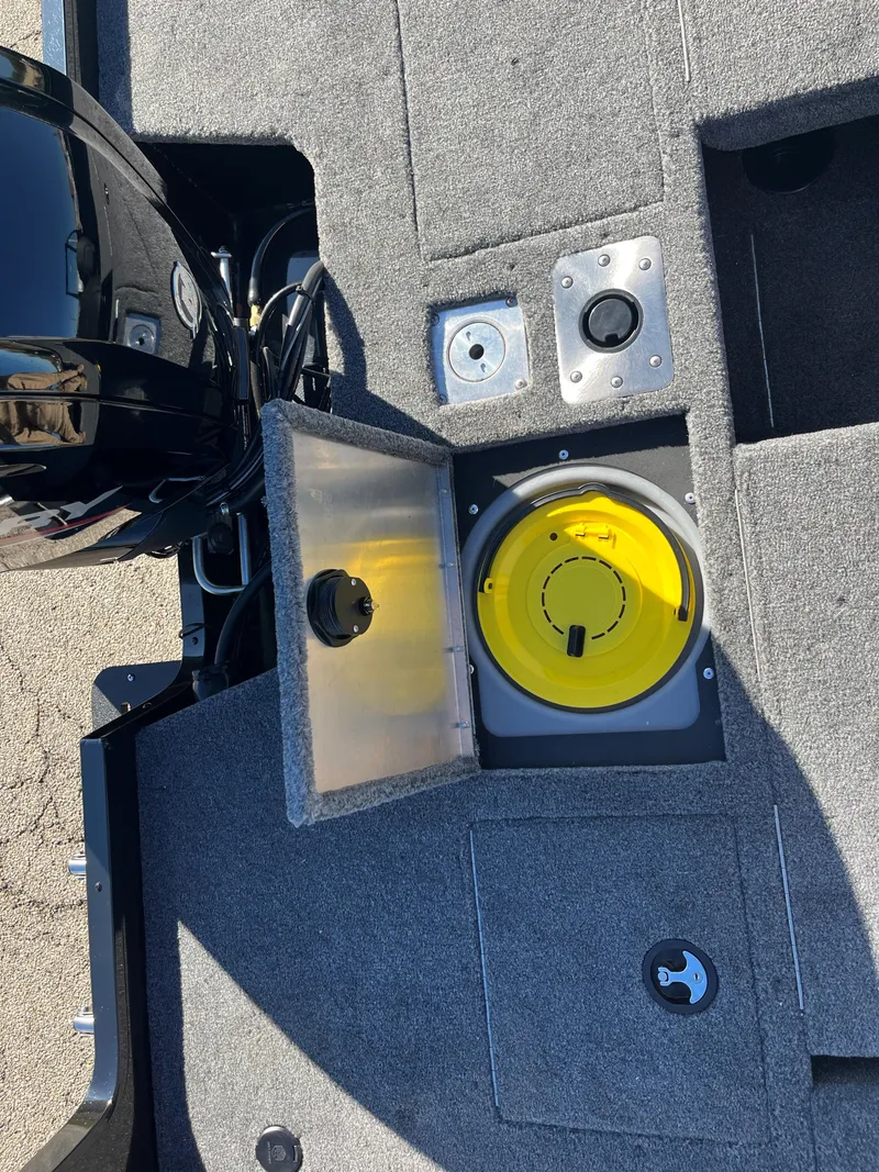 Slide: The Image of 2025 Tracker Pro Guide V-175 Combo boat interior with open storage compartment. - 14