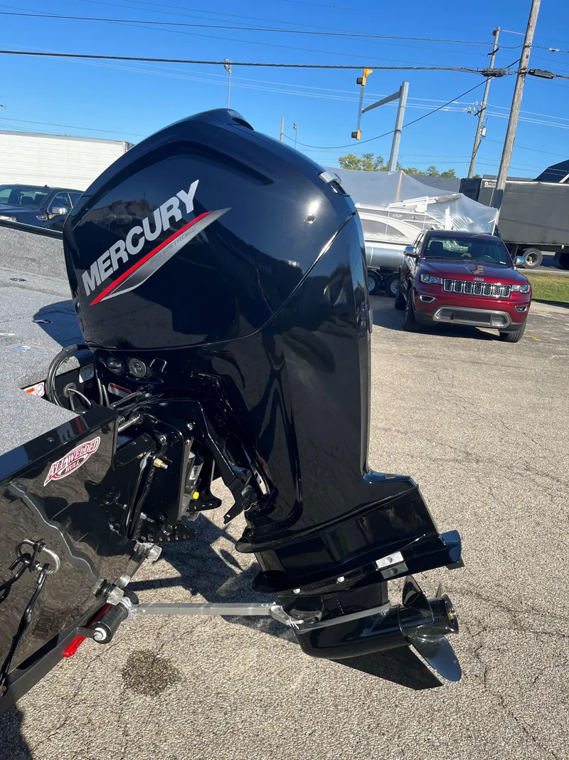 Slide: The Image of 2025 Tracker Pro Guide V-175 Combo with Mercury outboard motor in a parking lot. - 15