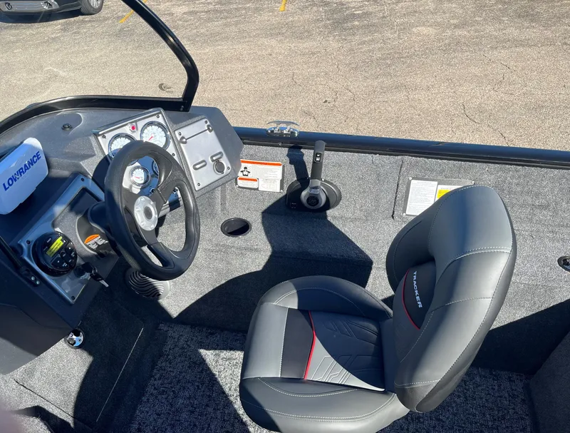Slide: The Image of 2025 Tracker Pro Guide V-175 Combo boat interior with steering wheel and seat. - 8