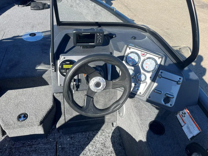 Slide: The Image of 2025 Tracker Pro Guide V-175 Combo boat dashboard with steering wheel and gauges. - 9
