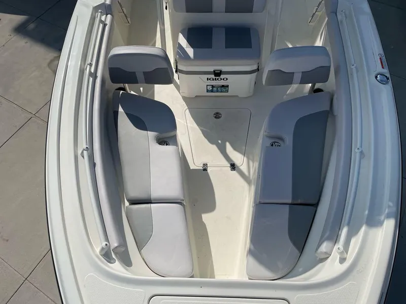 Slide: The Image of 2024 Mako 214 CC boat interior with cushioned seating and storage. - 2