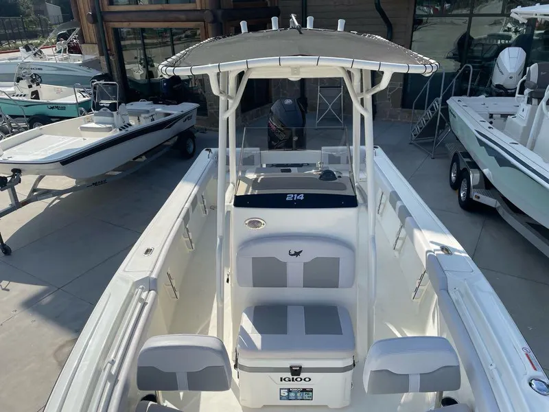 Slide: The Image of 2024 Mako 214 CC center console boat in a showroom display. - 3