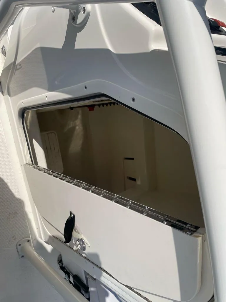 Slide: The Image of 2024 Mako 214 CC boat storage compartment with open hatch. - 6
