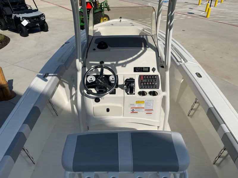 Slide: The Image of 2024 Mako 214 CC boat interior with steering console and seating. - 7