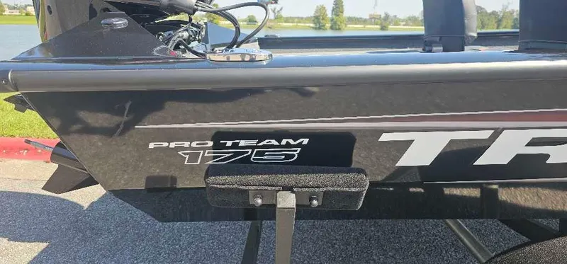 Slide: The Image of 2025 Tracker Pro Team 175 Crappie Edition boat, side view near a lake. - 2
