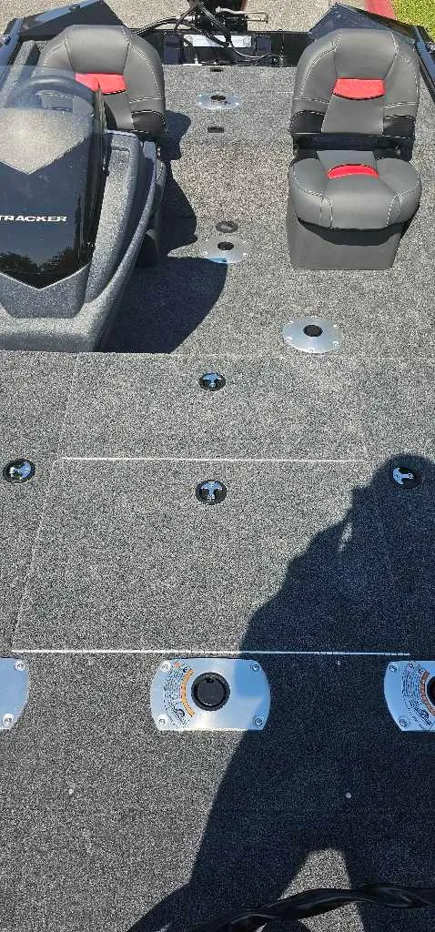 Slide: The Image of 2025 Tracker Pro Team 175 Crappie Edition boat interior with seating and carpeted deck. - 3