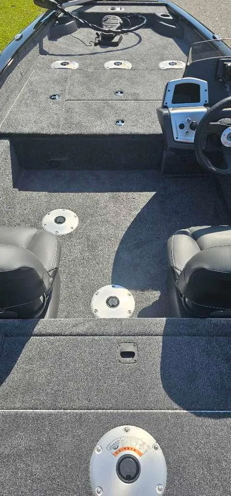 Slide: The Image of 2025 Tracker Pro Team 175 Crappie Edition boat interior with seating and control panel. - 4