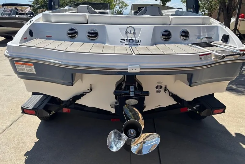 Slide: The Image of 2024 Tahoe 210 Si Limited boat rear view with propeller and swim platform. - 14