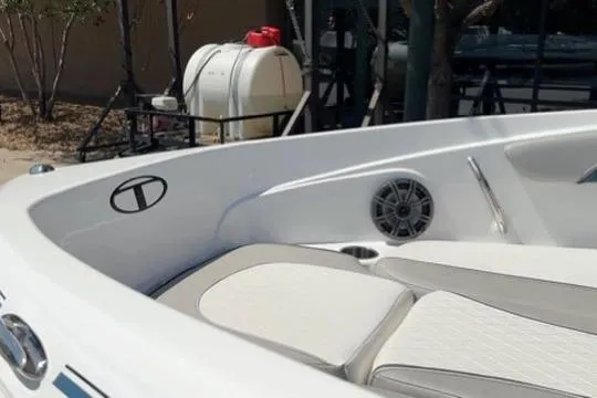 Slide: The Image of 2024 Tahoe 210 Si Limited boat interior with white seating and speaker detail. - 15
