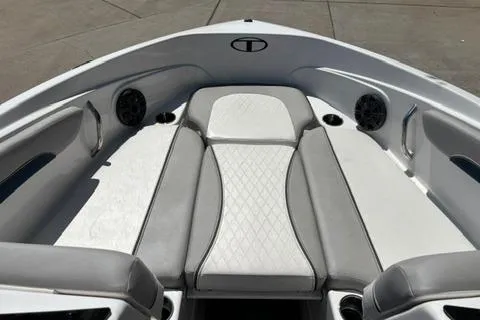 Slide: The Image of 2024 Tahoe 210 Si Limited boat interior with gray and white seating, cup holders, and speakers. - 5