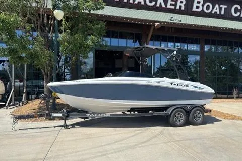 The Image of 2024 Tahoe 210 Si Limited boat on trailer outside dealership. - 0