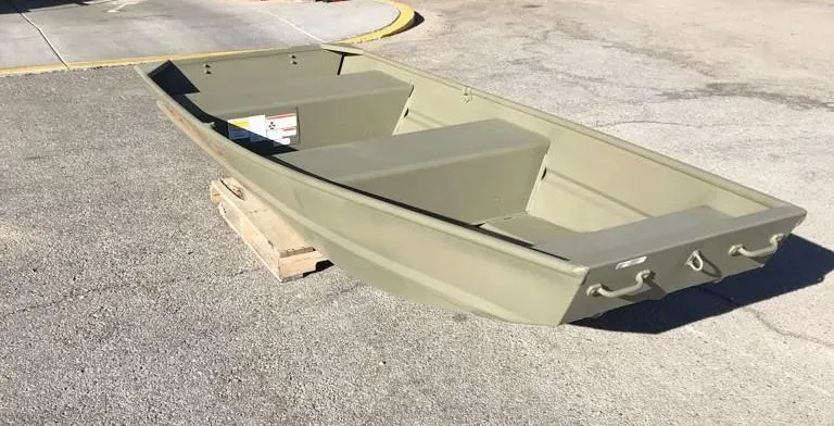 Slide: The Image of 2025 Tracker Grizzly 1236 Utility boat on pavement, olive green color. - 3