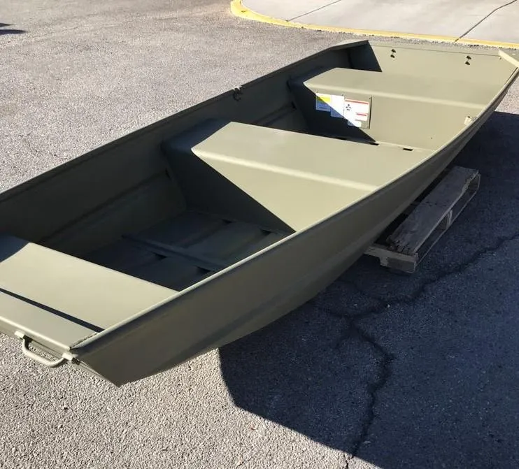 Slide: The Image of 2025 Tracker Grizzly 1236 Utility boat on pavement, side view. - 5