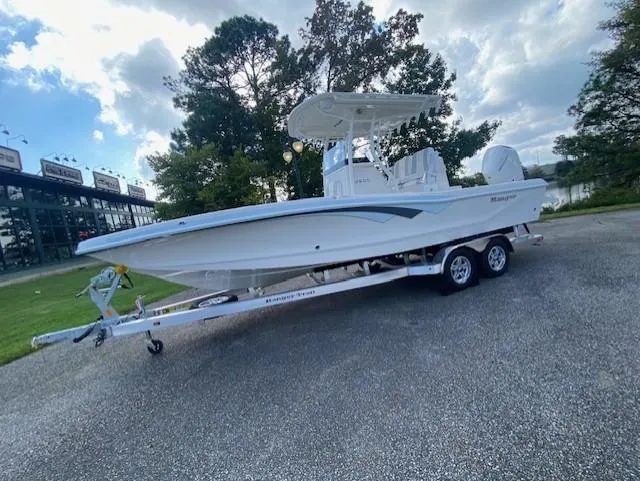 The Image of 2024 Ranger 2600 Bay boat on trailer, parked outdoors under cloudy sky. - 0