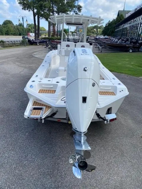 Slide: The Image of 2024 Ranger 2600 Bay boat, rear view, parked outdoors. - 3