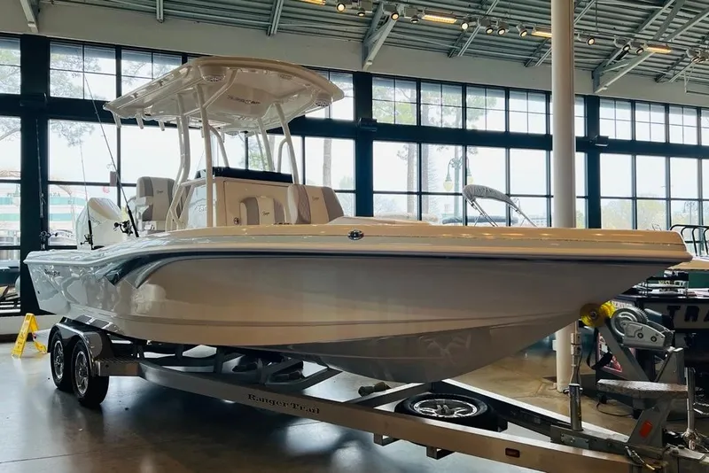 Slide: The Image of 2024 Ranger 2600 Bay boat on trailer in showroom, featuring sleek design and modern amenities. - 9