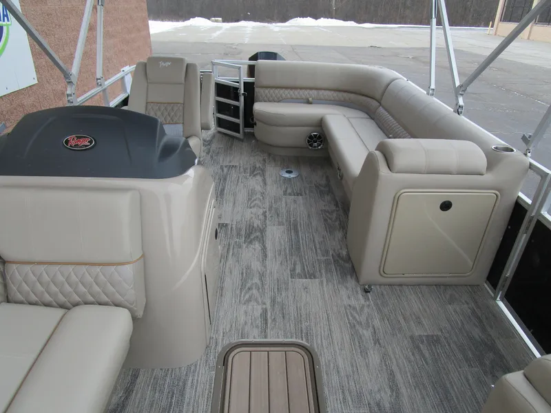 Slide: The Image of 2024 Ranger Reata 223C pontoon boat interior with beige seating and wood-style flooring. - 14