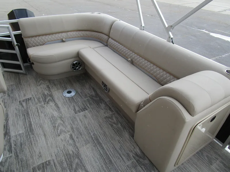 Slide: The Image of 2024 Ranger Reata 223C boat interior with beige seating and wood-patterned flooring. - 15