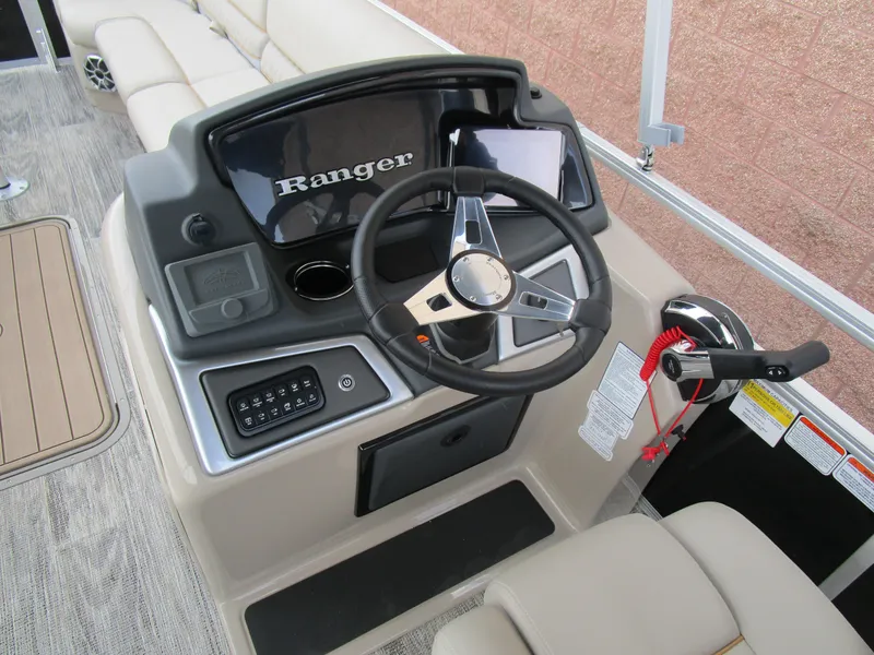 Slide: The Image of 2024 Ranger Reata 223C boat dashboard with steering wheel and controls. - 21