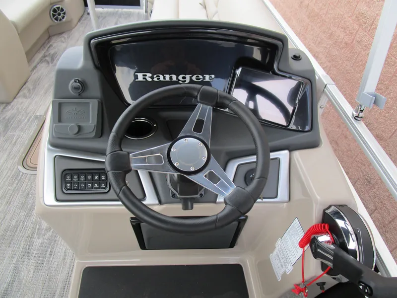 Slide: The Image of 2024 Ranger Reata 223C boat dashboard with steering wheel and controls. - 22