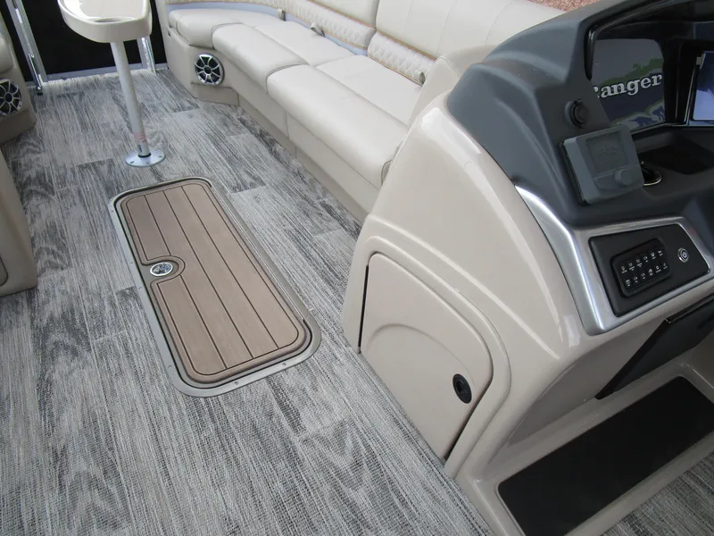 Slide: The Image of 2024 Ranger Reata 223C boat interior with beige seating and modern dashboard. - 25