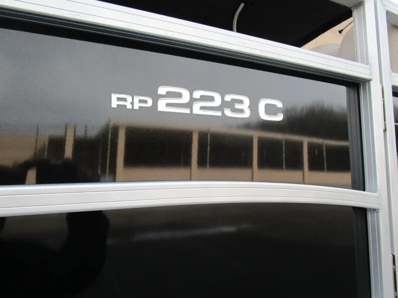 Slide: The Image of 2024 Ranger Reata 223C boat model nameplate on black surface. - 30