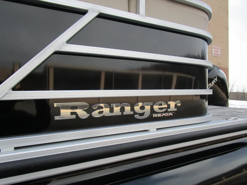 Slide: The Image of 2024 Ranger Reata 223C boat, close-up of logo and sleek black exterior design. - 31