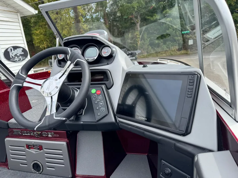 Slide: The Image of 2025 Ranger 620FS boat dashboard with steering wheel and navigation display. - 5