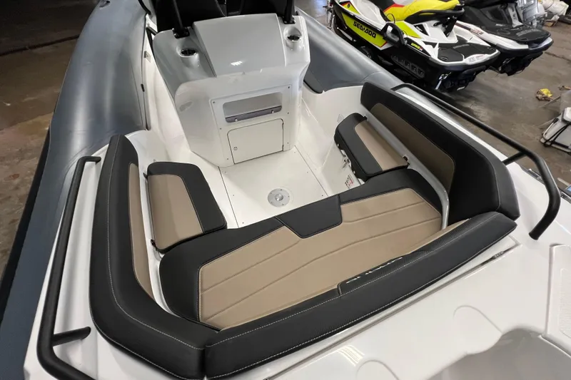 Slide: The Image of 2025 Grand G680 boat interior with beige and black seating, sleek design. - 2