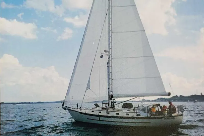 Slide: The Image of 1997 Pacific Seacraft 40 sailboat navigating open waters under a clear sky. - 1