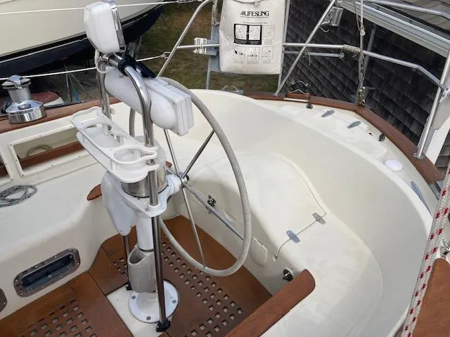 Slide: The Image of Cockpit of 1997 Pacific Seacraft 40 sailboat with steering wheel and wooden accents. - 12