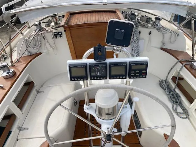 Slide: The Image of Cockpit of 1997 Pacific Seacraft 40 sailboat with steering wheel and navigation instruments. - 14