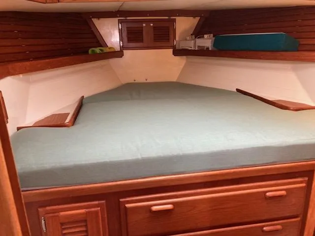 Slide: The Image of V-berth cabin in 1997 Pacific Seacraft 40 sailboat with wooden cabinetry and storage. - 15