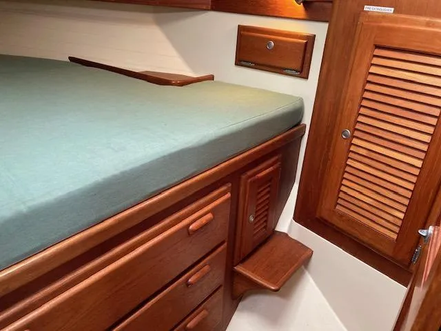 Slide: The Image of Cozy cabin interior of 1997 Pacific Seacraft 40 with wooden storage and bed. - 16