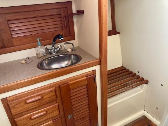 Slide: The Image of Compact bathroom in 1997 Pacific Seacraft 40 yacht with wooden cabinetry and stainless steel sink. - 20