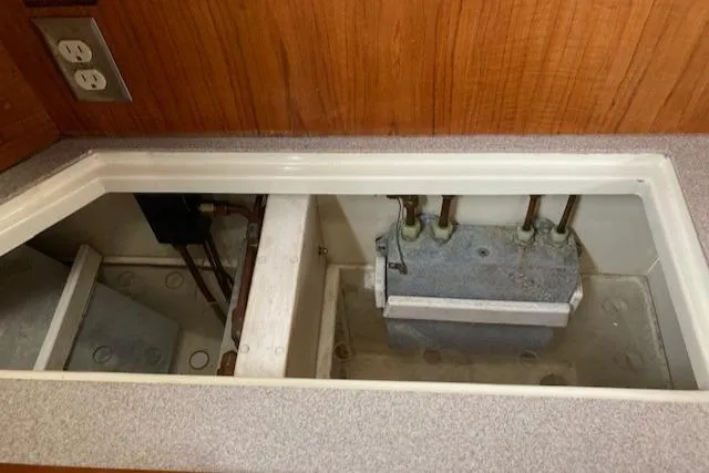 Slide: The Image of Electrical compartment of a 1997 Pacific Seacraft 40 sailboat, featuring wiring and outlets. - 22