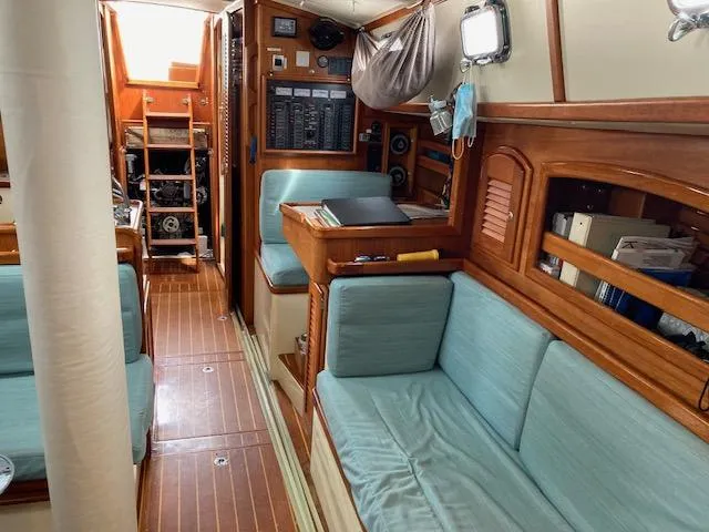Slide: The Image of Interior of 1997 Pacific Seacraft 40 sailboat with wooden finish and blue seating. - 28