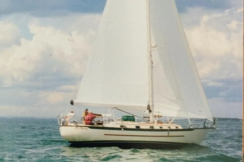 Slide: The Image of Sailing yacht Pacific Seacraft 40, 1997 model, cruising on open water under clear skies. - 3