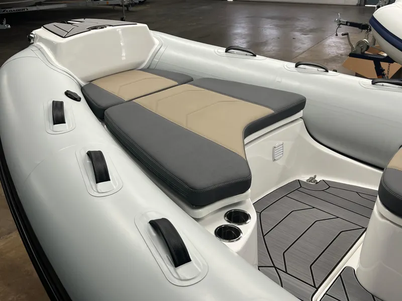 Slide: The Image of Interior view of 2025 Grand G500HLF boat with cushioned seating and cup holders. - 3