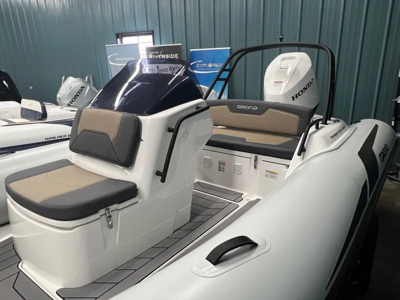 Slide: The Image of 2025 Grand G500HLF boat with Honda engine, featuring sleek seating and modern design in a showroom. - 4