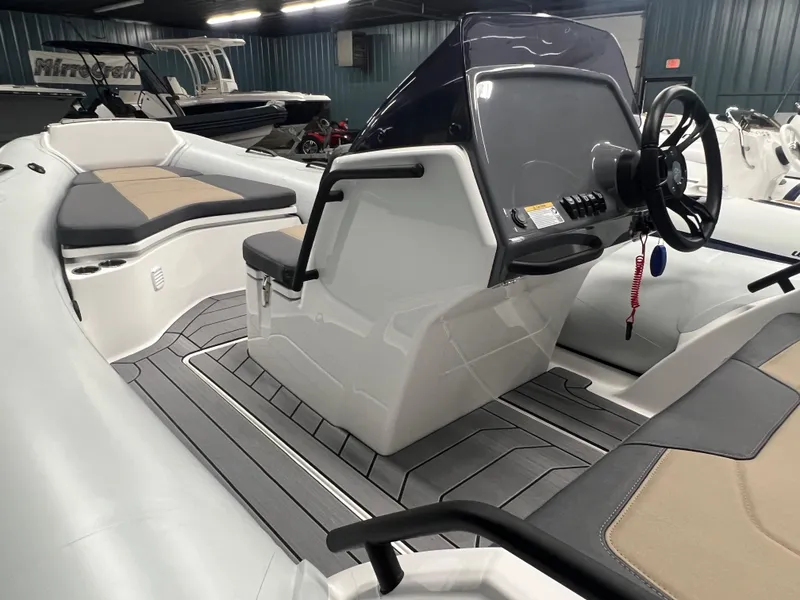 Slide: The Image of 2025 Grand G500HLF boat interior with modern console and seating in showroom. - 6