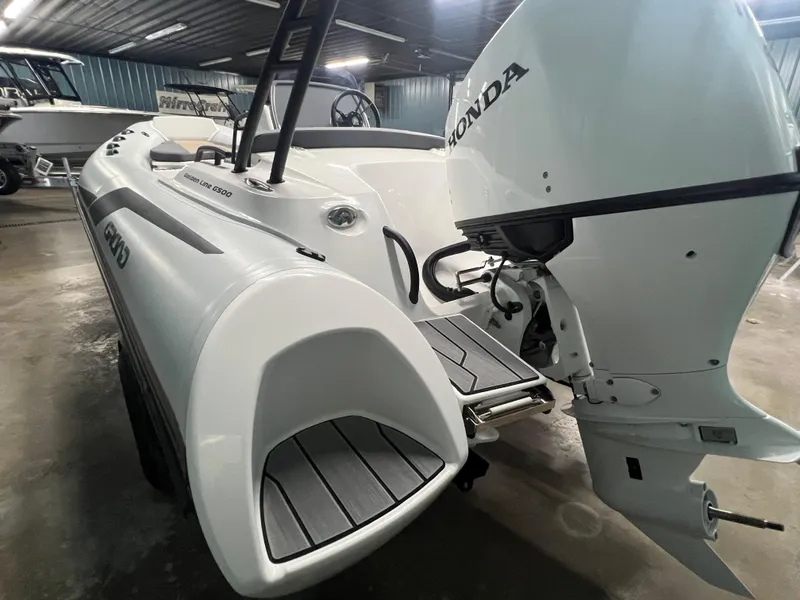 Slide: The Image of 2025 Grand G500HLF boat with Honda outboard motor in a showroom. - 7