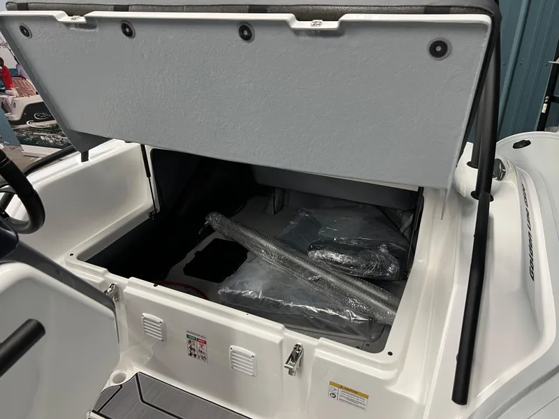 Slide: The Image of Open storage compartment in 2025 Grand G500HLF boat, showing interior space and packaging materials. - 9